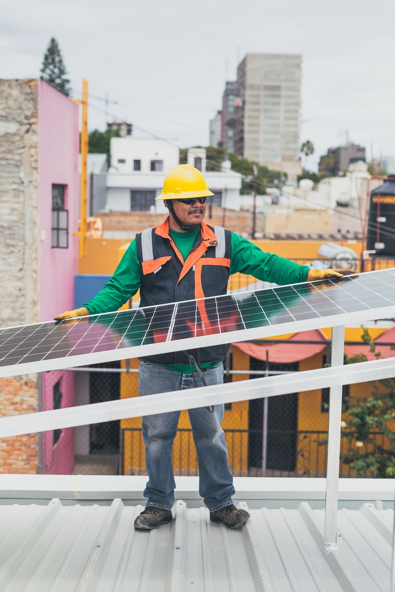 Brightly-certified installer fitting solar panels on a rooftop